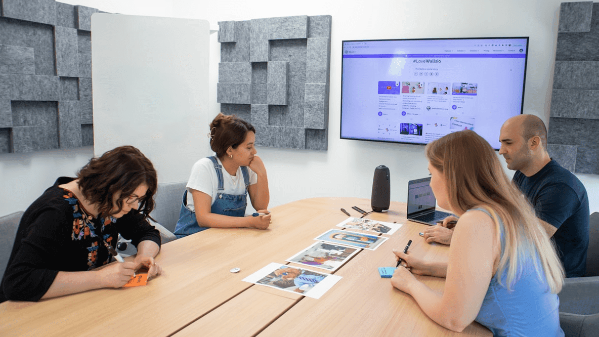 Team collaborating around a table with screens